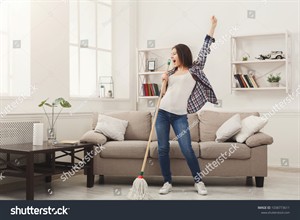 stock-photo-happy-woman-cleaning-home-singing-at-mop-like-at-microphone-and-having-fun-copy-space-housework-1038773611.jpg