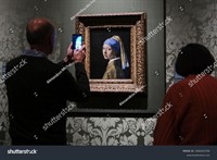 stock-photo-visitors-look-the-johannes-vermeer-s-painting-girl-with-a-pearl-earring-displayed-at-the-2584222705.jpg