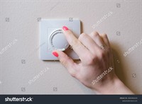 stock-photo-woman-s-hand-adjusts-the-lighting-with-a-dimmer-lever-an-electronic-device-designed-to-change-2081856229.jpg