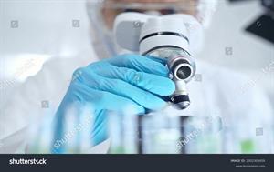 stock-photo-professional-scientist-in-protective-gear-is-using-microscope-in-a-laboratory-setting-close-up-2502303459.jpg