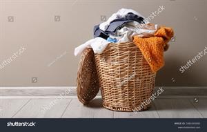 stock-photo-basket-with-dirty-laundry-on-floor-against-depicts-an-image-of-a-laundry-basket-filled-with-dirty-2481045685.jpg