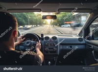 stock-photo-hands-on-the-wheel-when-driving-at-high-speed-from-inside-the-car-2196741669.jpg