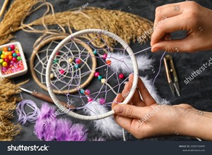 stock-photo-woman-making-dream-catcher-on-dark-table-closeup-2282716495.jpg