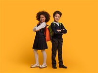 shutterstock_2468458031_kids in school uniforms_bērni skolas uniformā.jpg